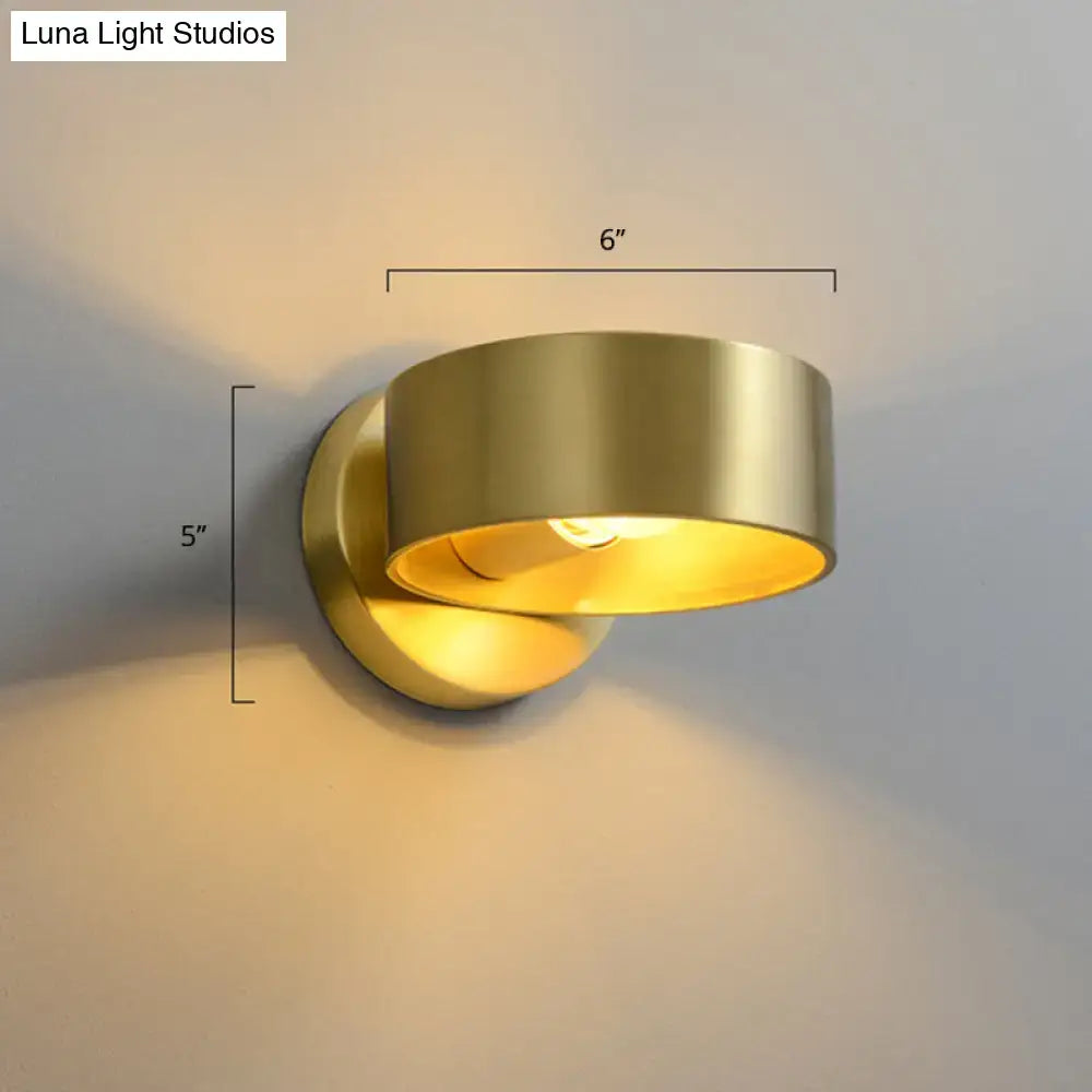 A minimalist brass curved wall lamp in brushed gold with warm yellow glow compatible with 110v-120v and 220v-240v