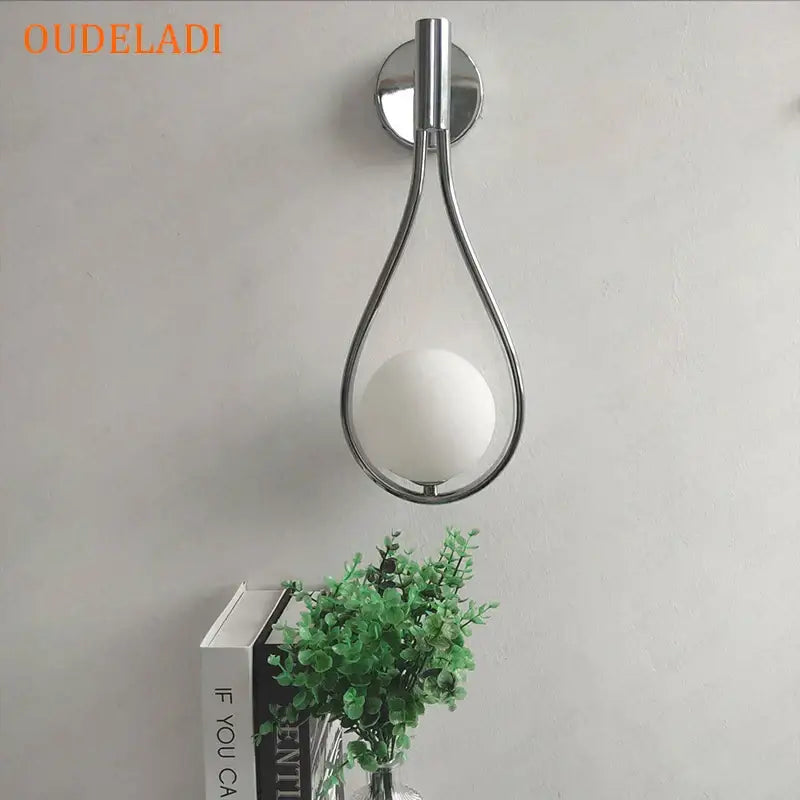 Minimalist brass glass ball wall sconce with chrome finished teardrop frame and frosted white glass ball bulb for living room decorbites brass glass