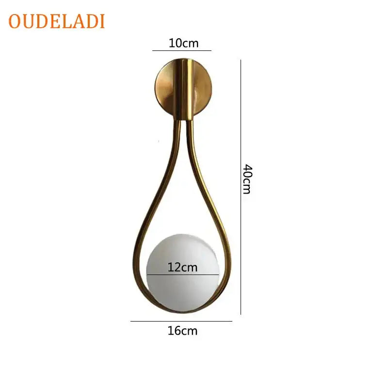 Minimalist gold-toned brass glass ball wall sconce with teardrop frame and frosted globe for living room decorbites brass glass