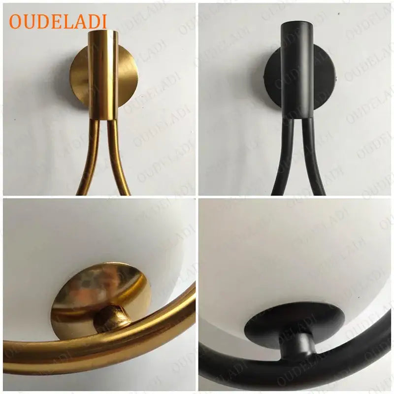 Modern minimalist brass glass ball wall sconce with cylindrical stem and curved arm in polished brass or matte black finish