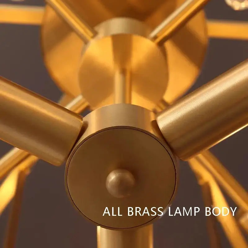 Minimalist brass glass bar chandelier with golden brass body and geometric intersecting cylindrical arms for living room decorbites brass glass