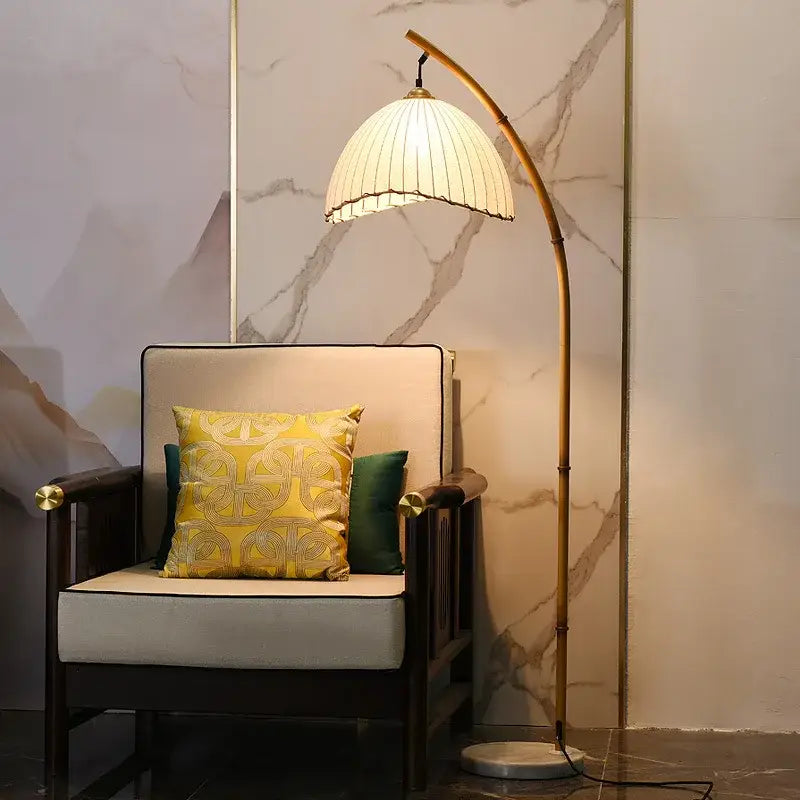 Minimalist brass led floor lamp with golden arched design, cream pleated shade, and marble base for living room lighting