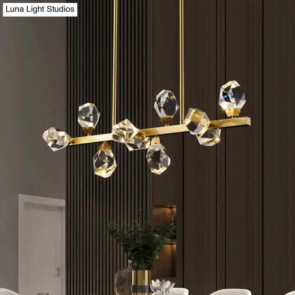 Gold-toned crystal chandelier with faceted glass elements in a minimalist brass led gemstone dining room ceiling light