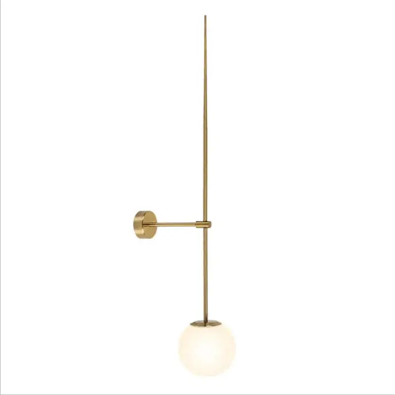 Minimalist brass led wall light with slender vertical rod and frosted glass globe shade for bedroom use
