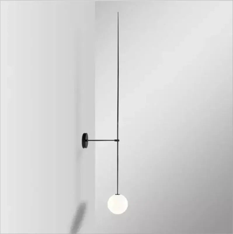 Minimalist black metal led wall sconce with a spherical frosted glass bulb designed as bedroom wall lights