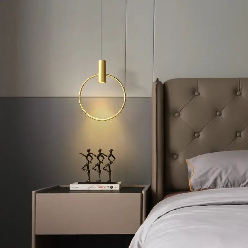 Minimalist gold pendant light featuring a brass ring chandelier design with cylindrical fixture for bedroom decorbites brass ring