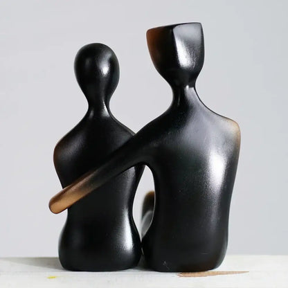 Black glossy resin couple sculptures featuring two abstract human forms embracing for minimalist bedroom decorbites elegant resin decor