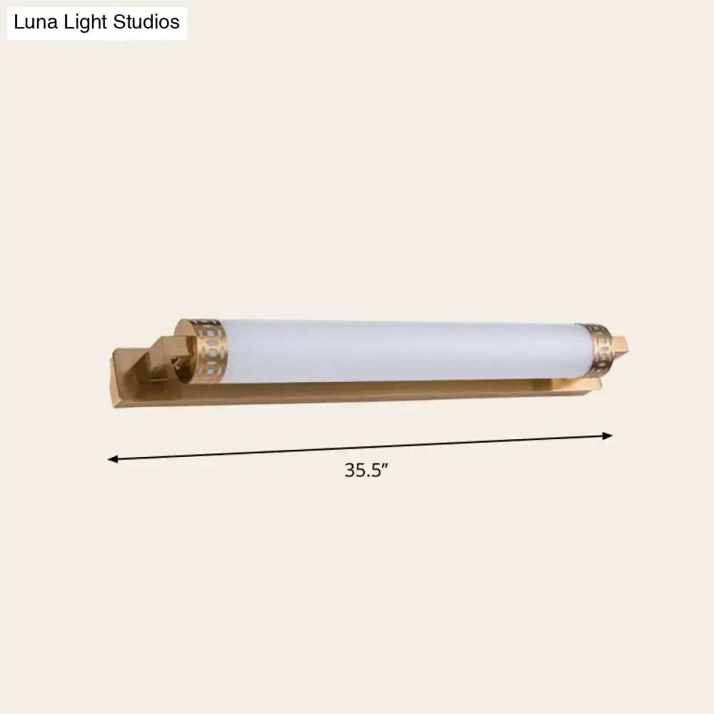Minimalist bronze wall light sconce with gold-toned finish frosted glass cylinder and decorative end caps for bathroom vanity