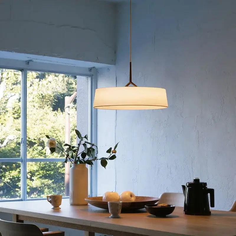 Minimalist bronze italian design fabric floor lamp with cylindrical linen shade and warm glow by decorbites italian design