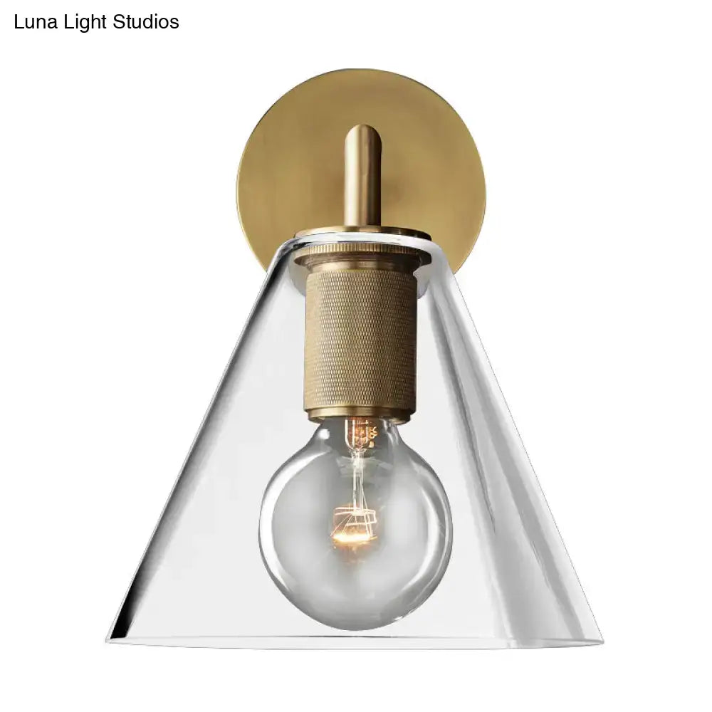 Modern brass-finished DecorBites™ minimalist wall sconce with clear glass shade and exposed light bulb