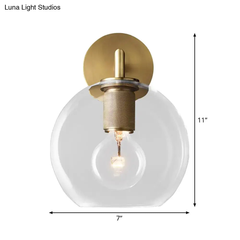 DecorBites™ minimalist bronze wall sconce with brushed brass finish clear glass shade and exposed light bulb