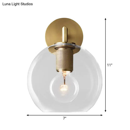 DecorBites™ minimalist bronze wall sconce with brushed brass finish clear glass shade and exposed light bulb