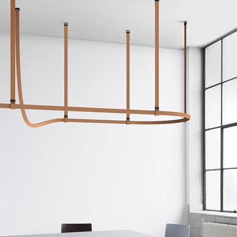 Minimalist brown leather hanging clothes drying rack with tan leather straps and black metal pendant lamp decorbites belt