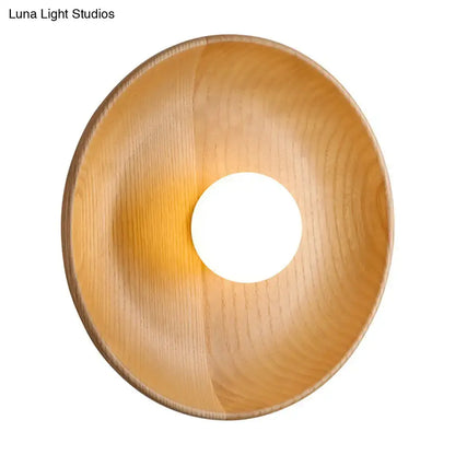 Minimalist brown wood wall light with light wood-finished bowl and circular cutout featuring fixture height design