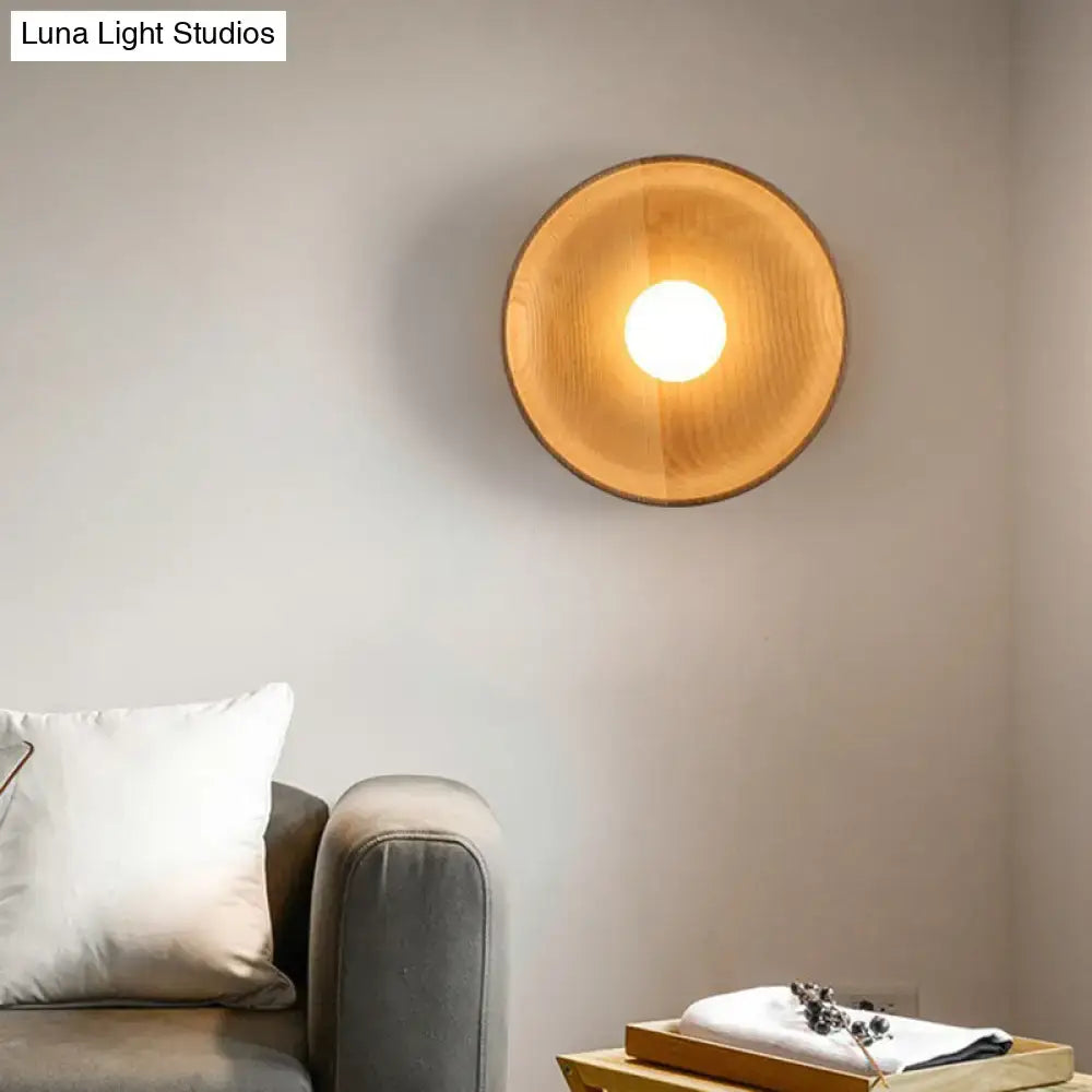 Minimalist brown wood wall light with warm-toned circular wooden sconce and smooth natural finish for living room use