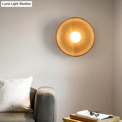 Minimalist brown wood wall light with warm-toned circular wooden sconce and smooth natural finish for living room use