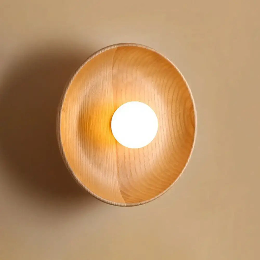 Minimalist brown wood wall light with a warm-toned wooden bowl fixture featuring smooth natural grain and rounded edges