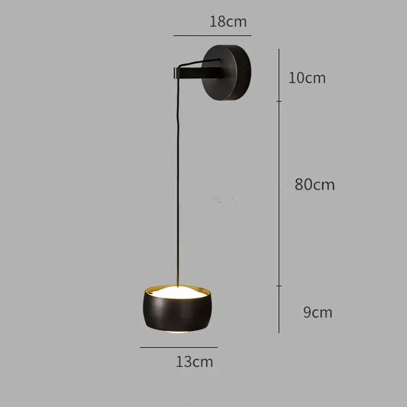Minimalist wall lamp with black matte finish, brushed brass trim, and copper adjustable led design for bedroom decorbites