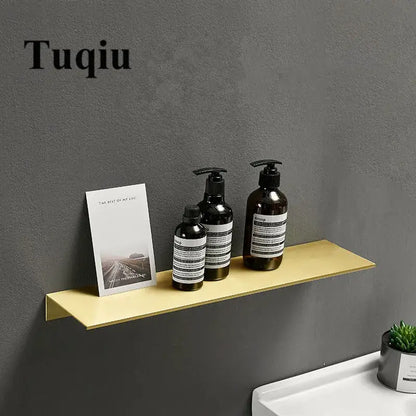 Minimalist brushed gold bathroom shelf wall mounted shampoo rack with gold-colored metal holding essentials decorbites brushed gold