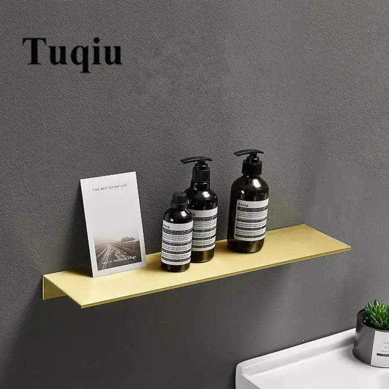 Minimalist brushed gold bathroom shelf wall mounted shampoo rack with gold-colored metal holding essentials decorbites brushed gold