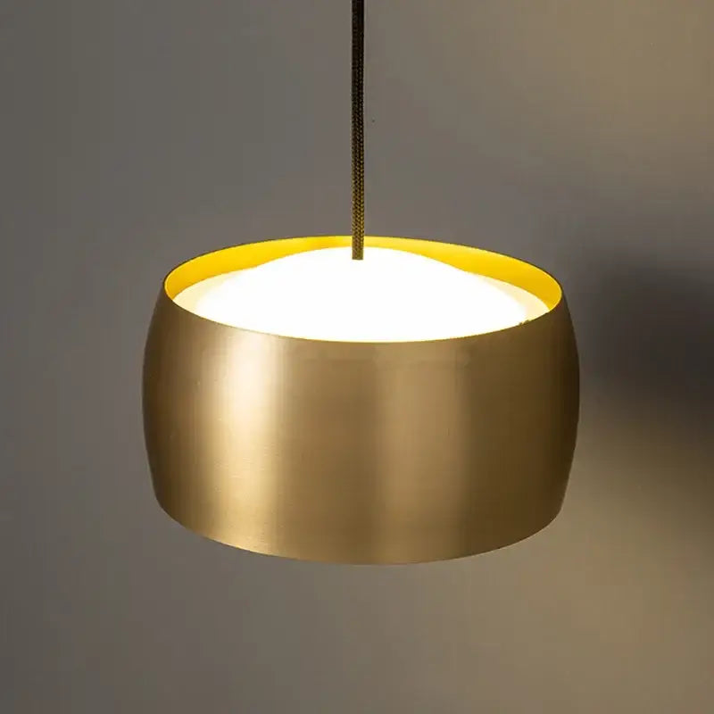 Minimalist brushed gold wall lamp with vibrant yellow interior lining designed as a decorbites copper adjustable reading light