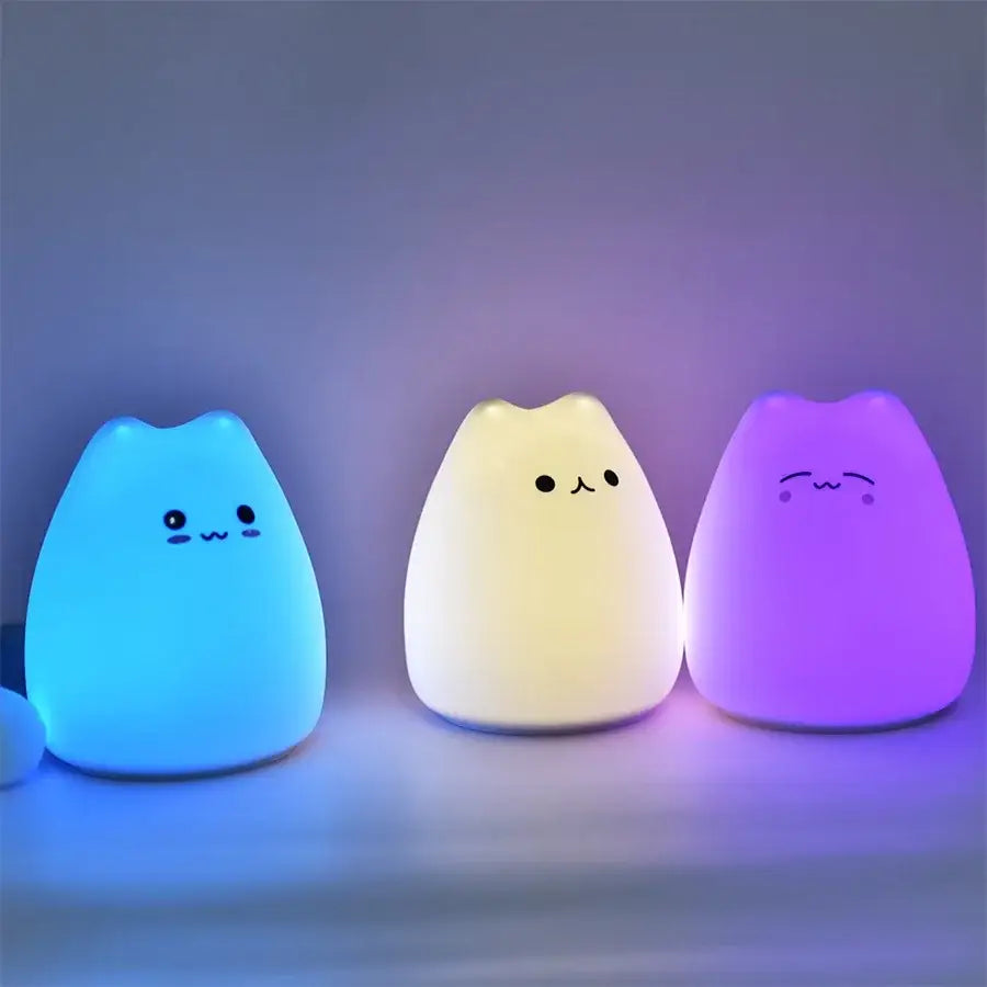 Three soft-glowing minimalist decorbites cat silicone led night lights in blue white and purple for bedroom use