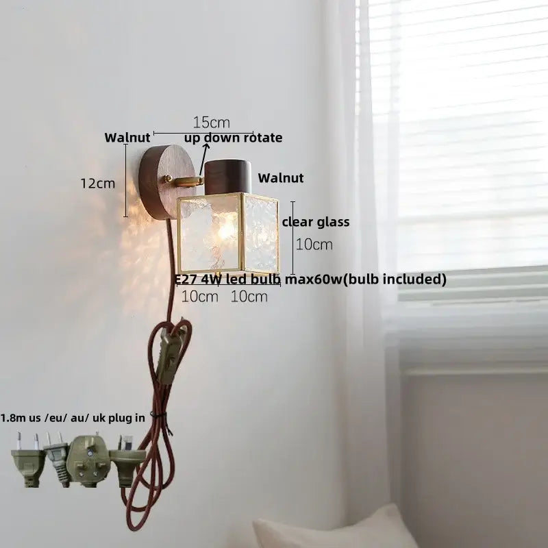 Wall light with ceramic walnut wood finish, walnut circular backplate, brass accents, and clear glass panels by decorbites