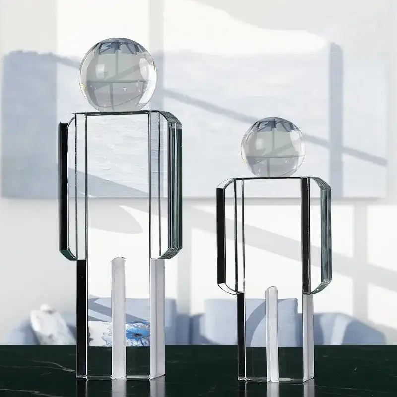Minimalist chrome decorbites crystal man statue featuring transparent geometric glass design with spherical heads for living room