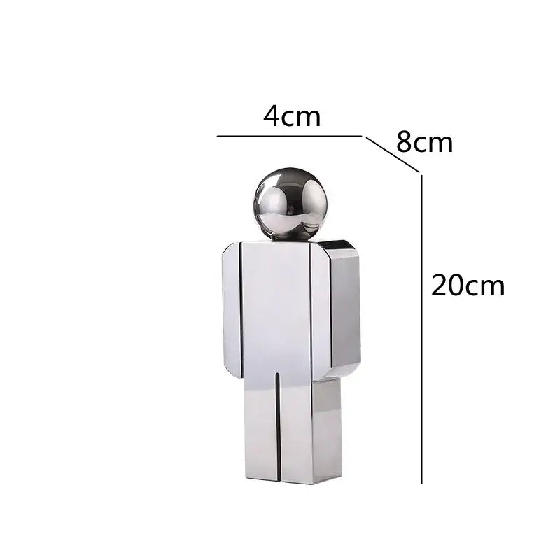 A sleek minimalist silver metallic decorbites crystal man statue with a spherical head and geometric body for living room decor
