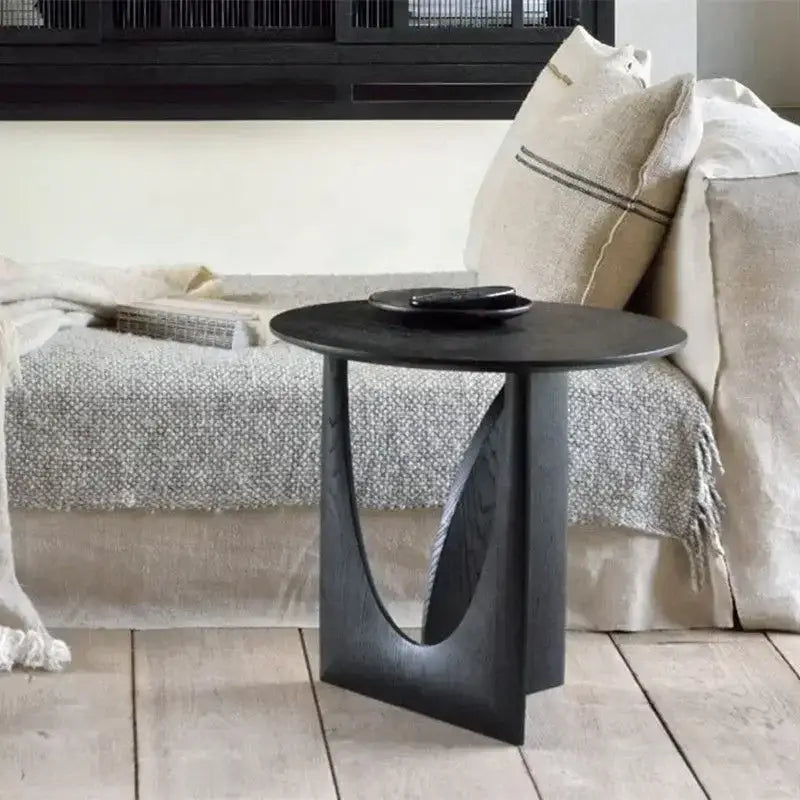 Black minimalist coffee table with curved geometric base and smooth circular walnut wood top for living room decorbites circular walnut