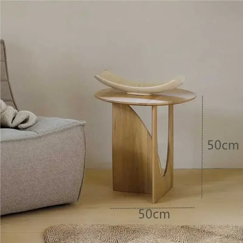 Minimalist circular walnut wood coffee table with light wood curved design and cream ceramic bowl for living room decorbites