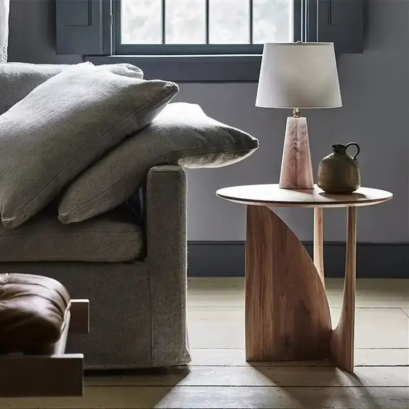 A minimalist circular walnut wood coffee table with a sleek curved base for modern living room decorbites circular walnut
