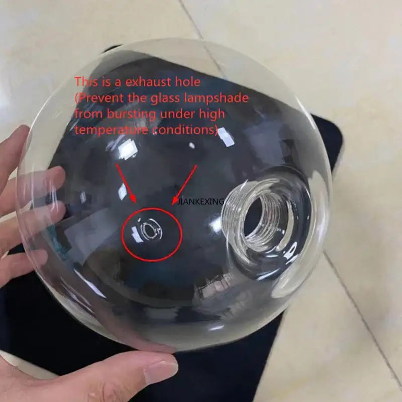 Minimalist clear glass bubble led pendant light with circular exhaust hole and threaded bulb attachment for dining room decorbites glass bubble