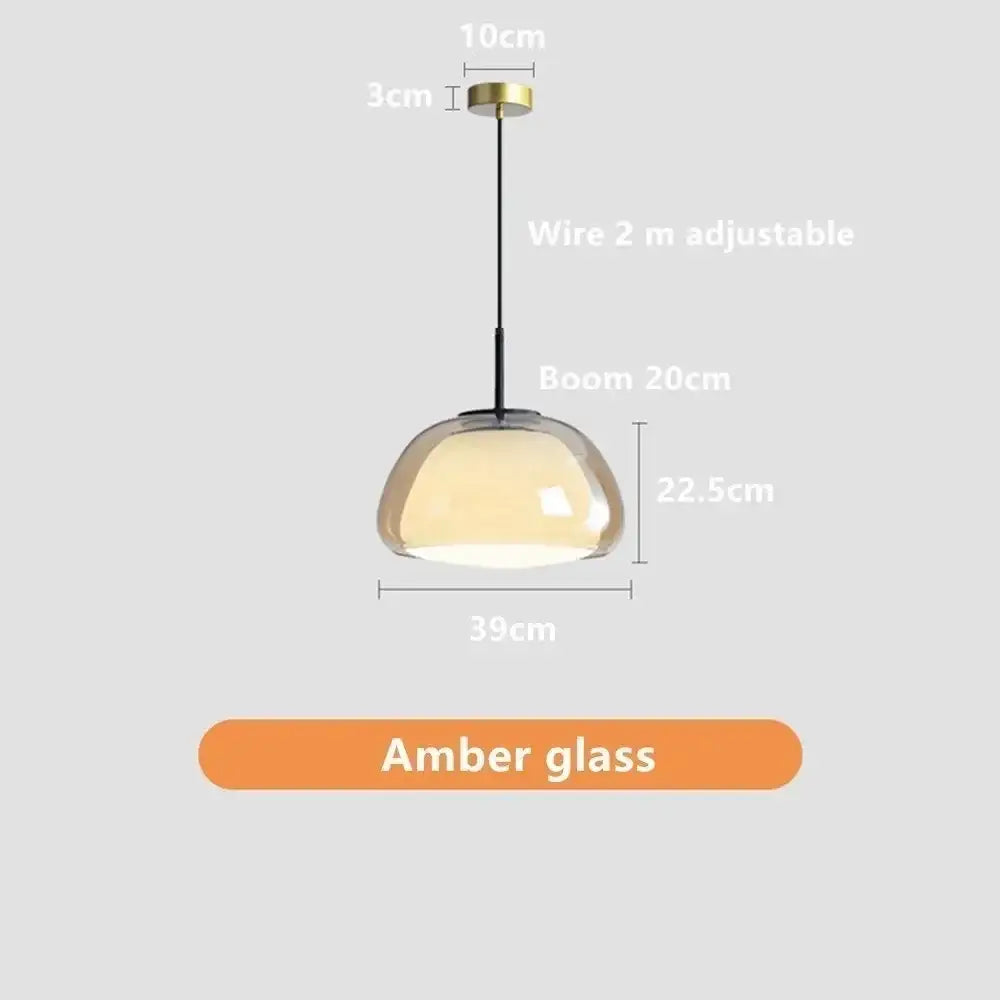 Minimalist jelly pendant lamp with a sleek amber glass dome shade and brass ceiling mount for living room
