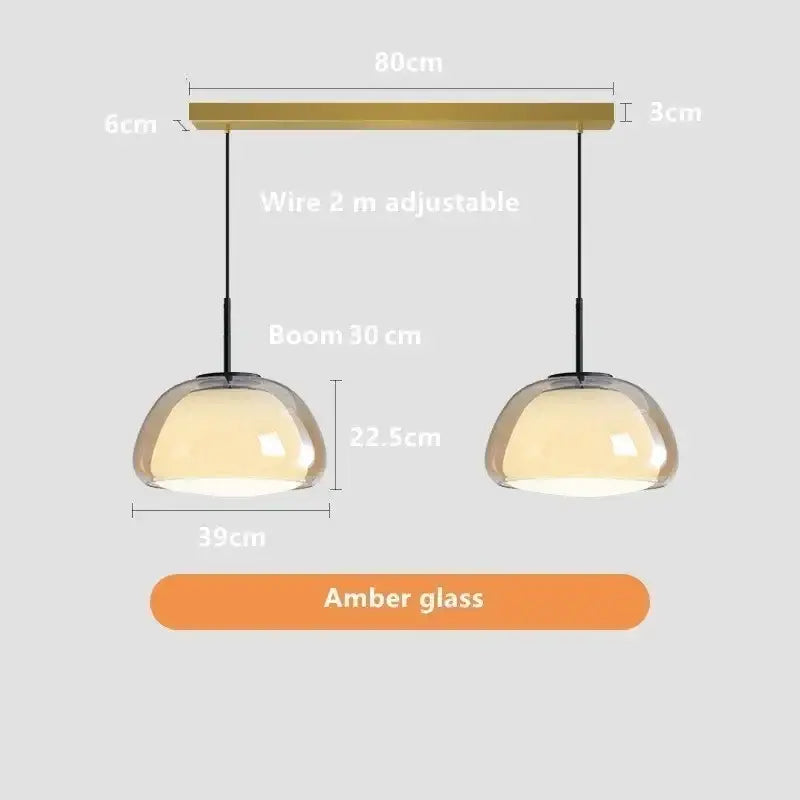Minimalist jelly pendant lamp with amber glass, brass-finished bar, and adjustable black cords for living room lighting