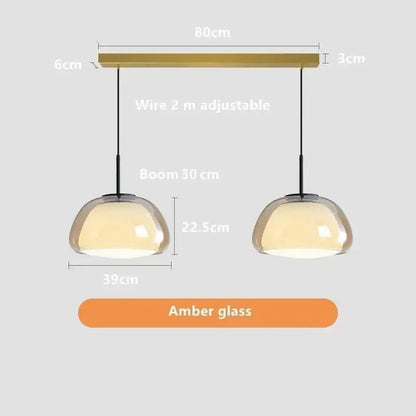 Minimalist jelly pendant lamp with amber glass, brass-finished bar, and adjustable black cords for living room lighting