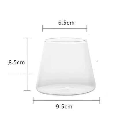 Minimalist clear glass water cup with tapered wide base and narrow rim for kitchen and dining room use