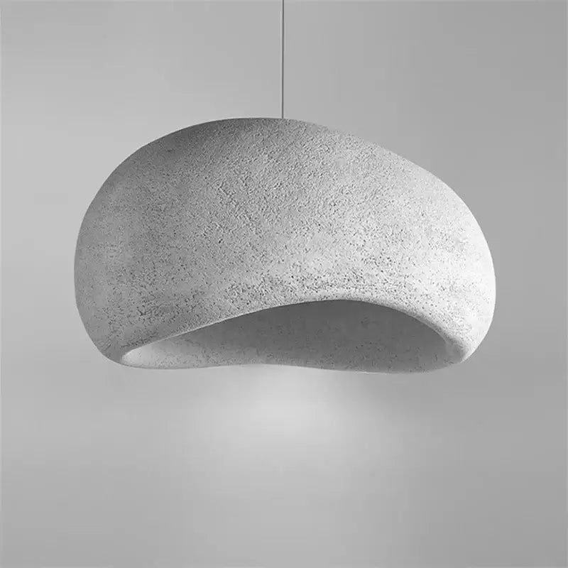 Minimalist concrete cobblestone pendant light with smooth organic dome and textured surface for dining room decorbites pendant lights