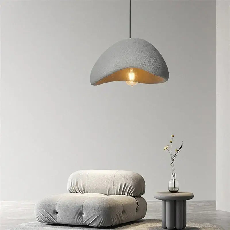 Gray textured decorbites cobblestone pendant lights with warm interior and exposed bulb ideal for dining room decor