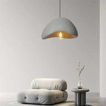 Gray textured decorbites cobblestone pendant light with warm interior and exposed bulb for minimalist dining room decor