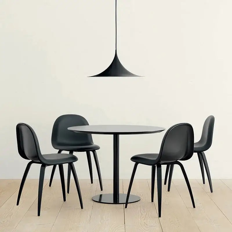 Black minimalist dining set with sleek chairs and round table under minimalist copper horn chandelier pendant light for dining room