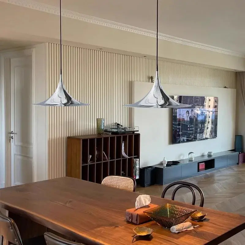 Two sleek chrome-finished pendant lights with modern trumpet shape for dining room decorbites horn chandelier pendant