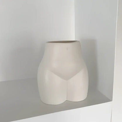 Cream-colored ceramic abstract human body vase shaped like stylized human torso for minimalist decorbites bedroom decor