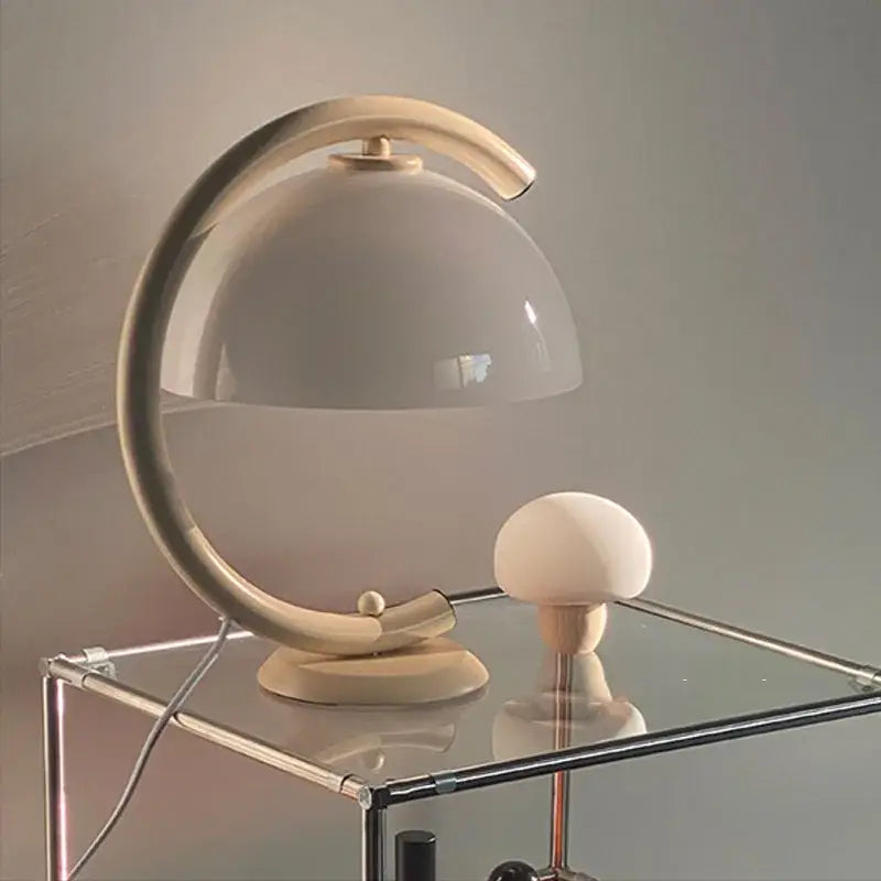 Minimalist cream bauhous mushroom table lamp with curved metallic base and translucent dome shade for bedroom use
