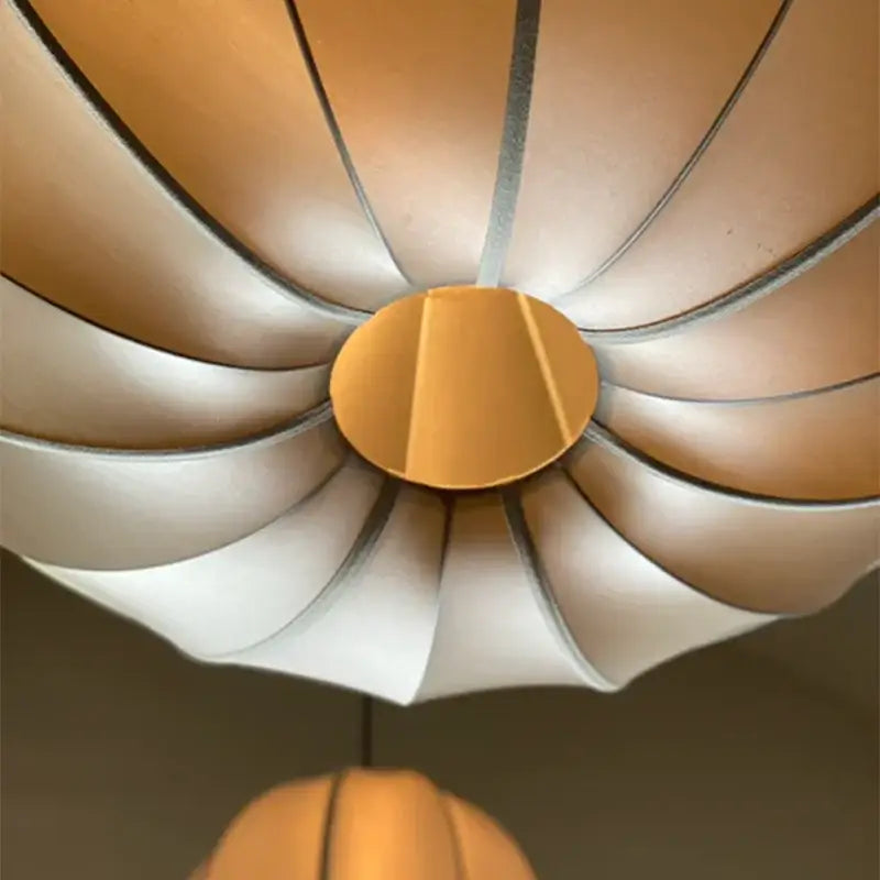 A modern petal-shaped pendant light with a warm beige and white gradient finish for dining room decorbites danish pendant