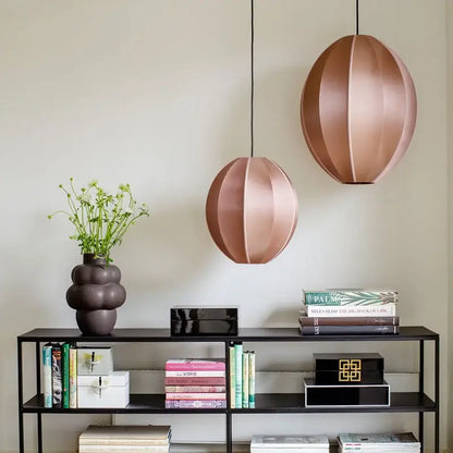 Two rose gold segmented spherical pendant lights complement minimalist cream and black geometric dining room decorbites danish pendant light