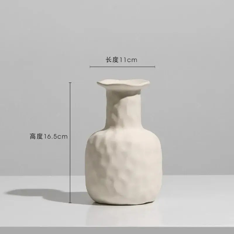 Minimalist cream ceramic art vase with a textured handcrafted surface and flared rim for decorbites ceramic decor