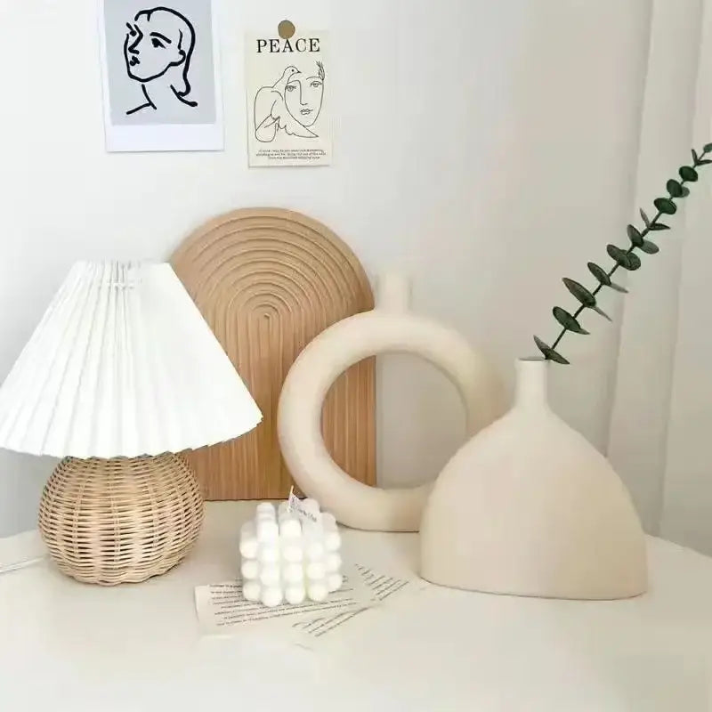 Minimalist cream ceramic art vase with smooth rounded body and narrow neck for living room decor by decorbites ceramic art