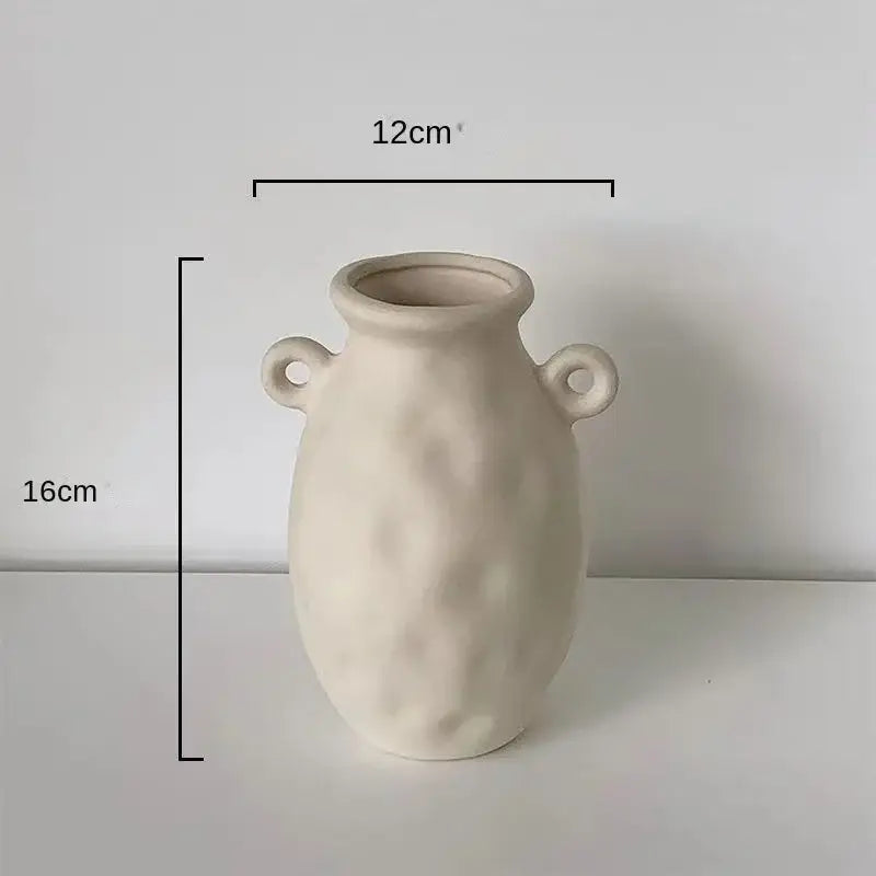Minimalist cream ceramic art vase with textured surface and looped handles by decorbites ceramic perfect for living room decor
