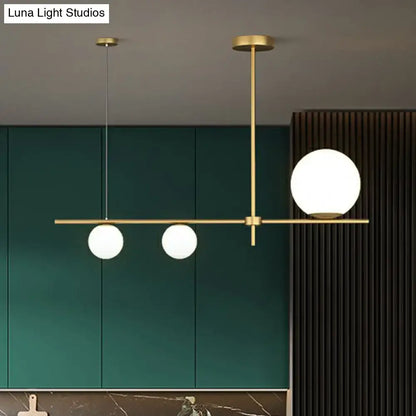 Modern brass pendant light with three cream glass globe island frosted globes for dining room lighting